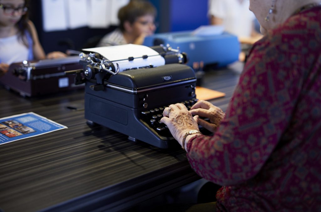 A visitor uses a typewriter