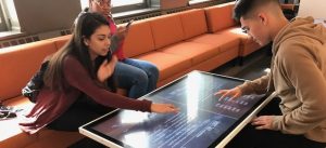 Two high school students on a field trip play a game at the Word Play tables at the American Writers Museum in Chicago, IL