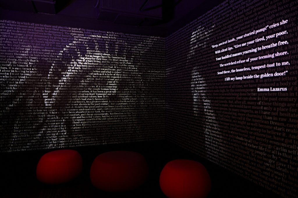 An exhibit at the AWM featuring words lit to look like the Statue of Liberty