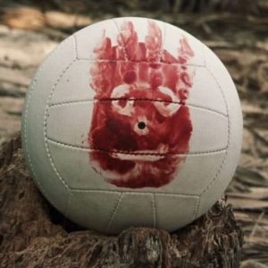 Still image from Cast Away of volleyball with face painted on it in blood
