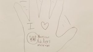 A drawing of a waving hand with "I love American Writers Museum" written on the palm