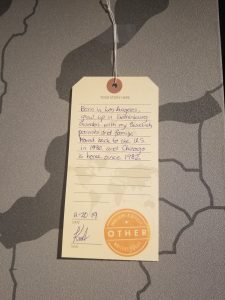 A luggage tag showcasing an immigration story of a visitor to the My America: Immigrant and Refugee Writers Today exhibit at the American Writers Museum in Chicago, IL