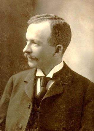 Sepia photo of Charles Chesnutt facing left. 