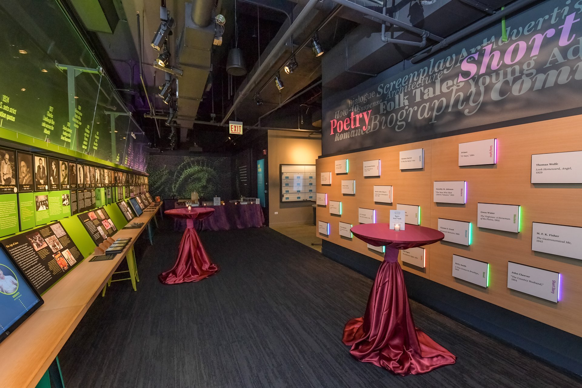 A cocktail event at the American Writers Museum in which 2 tables are set up in the Nation of Writers gallery
