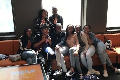 A group of teen students posing on a couch at the American Writers Museum in Chicagp