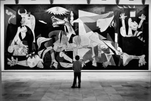 Black and white photo of a child looking at art