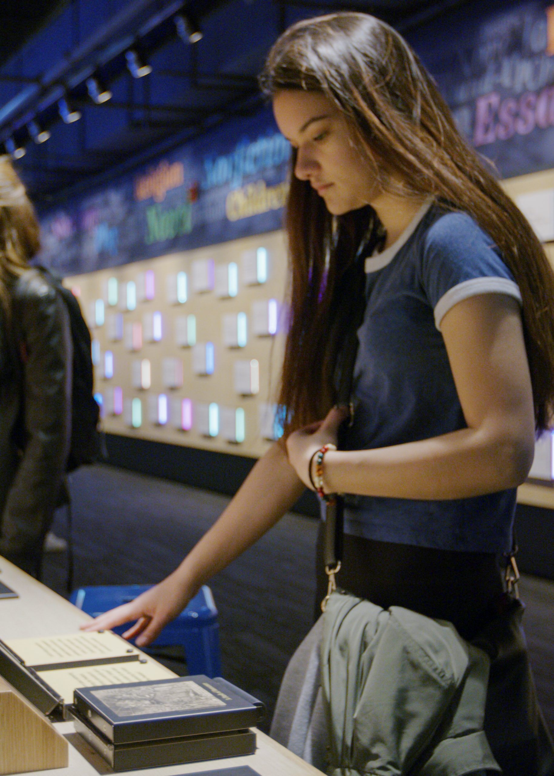 A teen girl on a field trip looks at an exhibit at the American Writers Museum