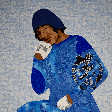 A quilt depicting Zora Neale Hurston sitting in a blue dress and white gloves on a light blue background