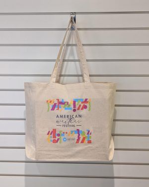 An off-white canvas tote bag with a rainbow colored punctuation design surrounding the words "American Writers Festival." The American Writers Museum logo is in the center of the lower rainbow design.